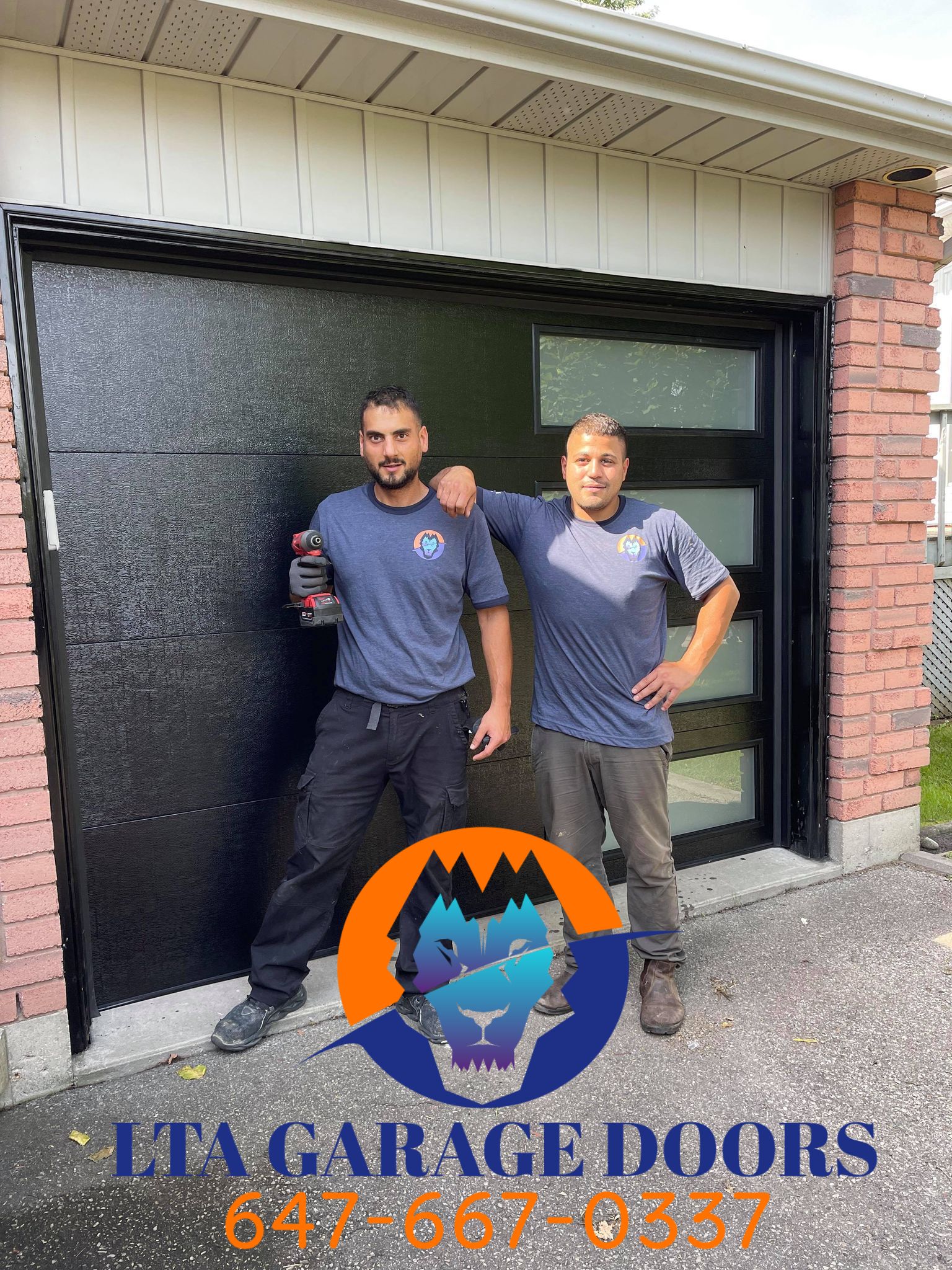 Two LTA Garage Doors technicians posing in front of a completed black contemporary garage door installation